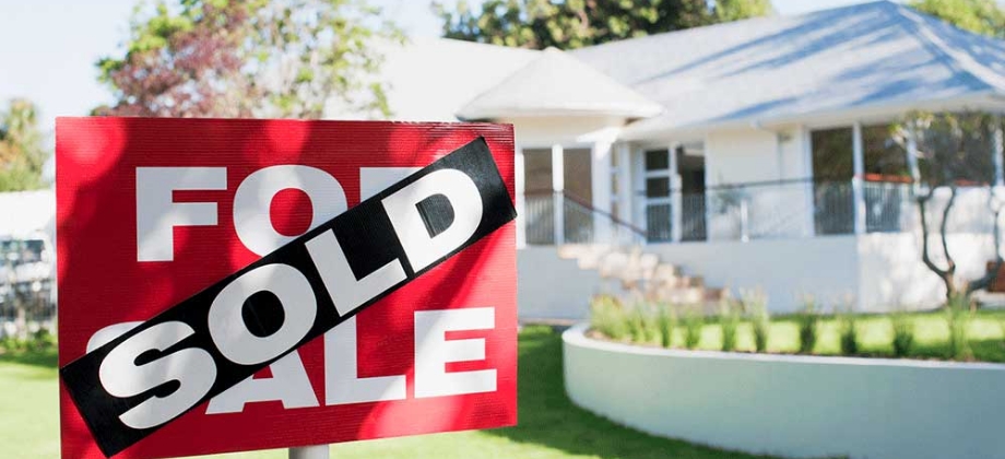 Sold sign in front of house