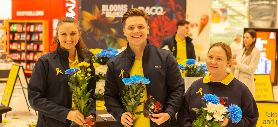 2025 Blooms for Blokes three racq people holding flowers