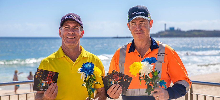 racq staff man and traffic response man holding flowers