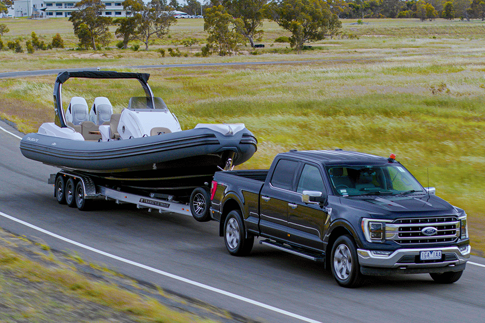 Ford F-150 pickup towing a boat.