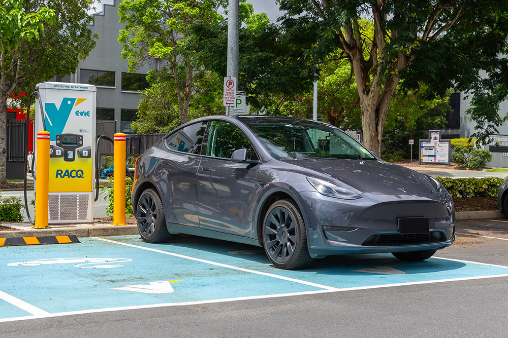 Tesla reacharging at an Evie charging station.