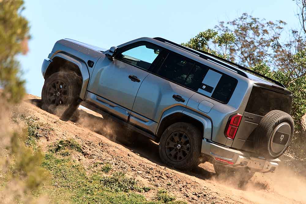Side view of Denza B5 Leopard climbing dirt hill