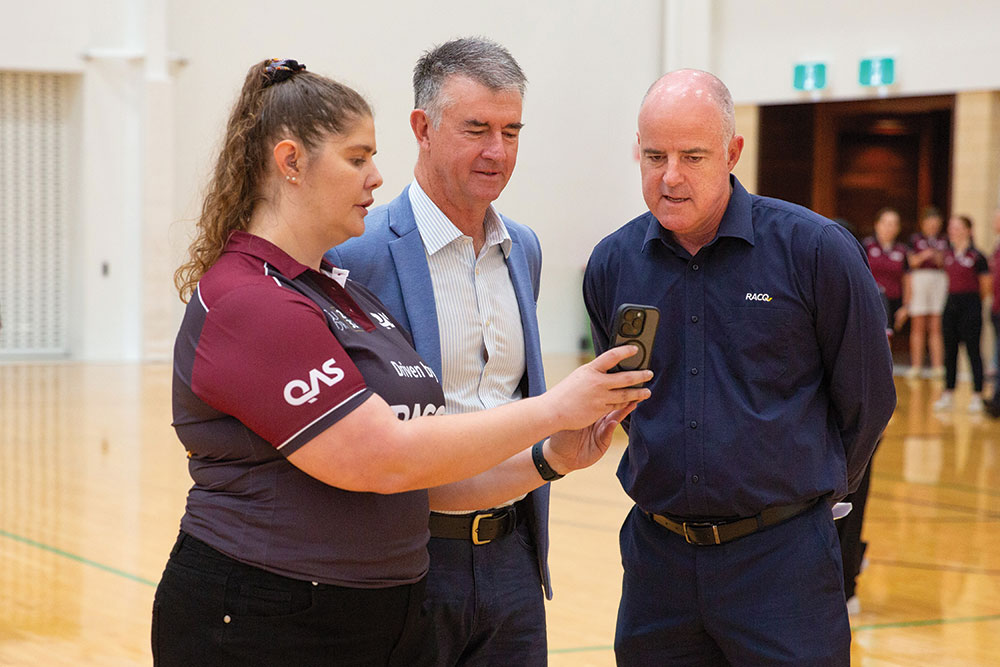 Sports Minister Tim Mander and RACQ CEO David Carter are shown the YourFor32 app.