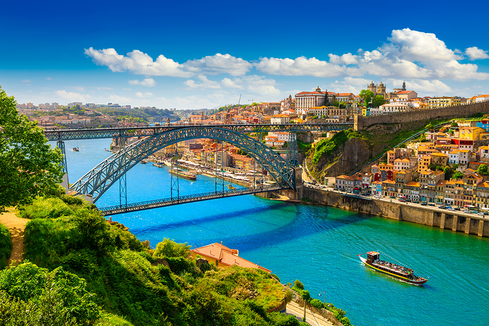  Panoramic view of Porto, Portugal, with colourful Ribeira buildings and the Dom Luís I Bridge over the Douro River 