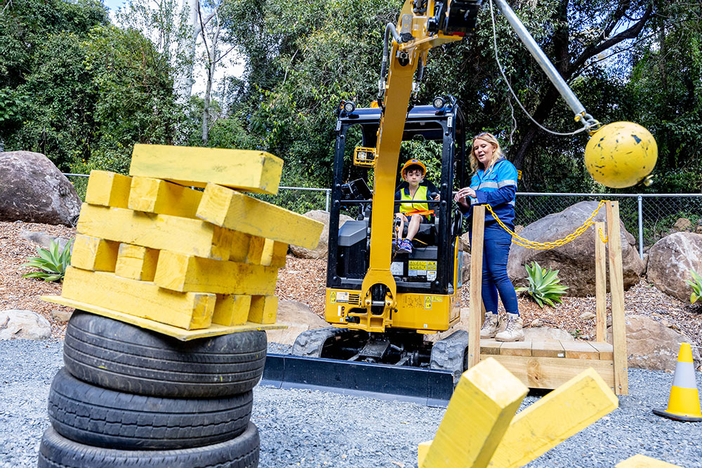 Kid having fun at Dig It excavator park at Tamborine Mountain.