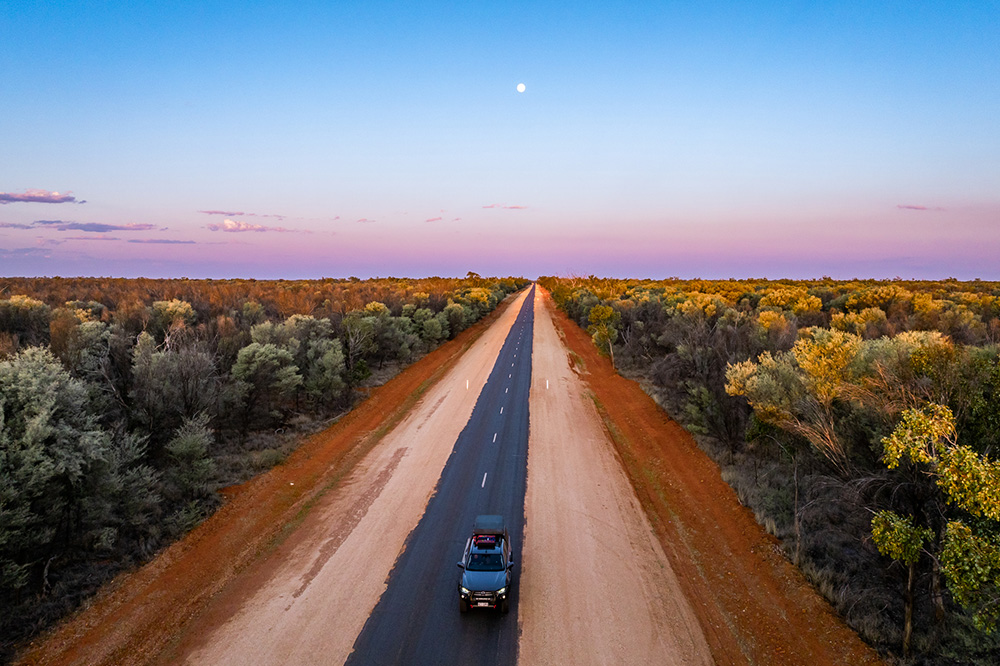 Vehicle driving down a road in the St George region of South West Queensland.