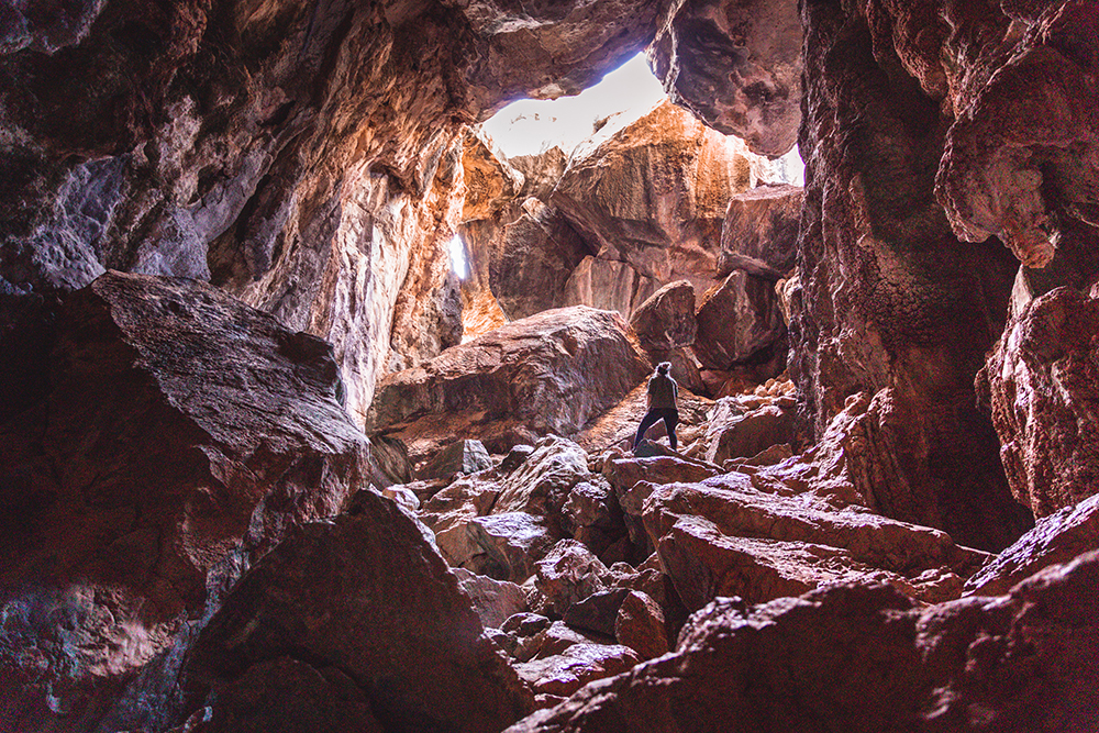 Person standing at the entrance to Pompeii Cave in the Chillagoe-Mungana Caves National Park.
