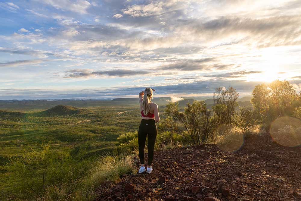 Woman standing on a hill overlooking a landscape in North West Queensland