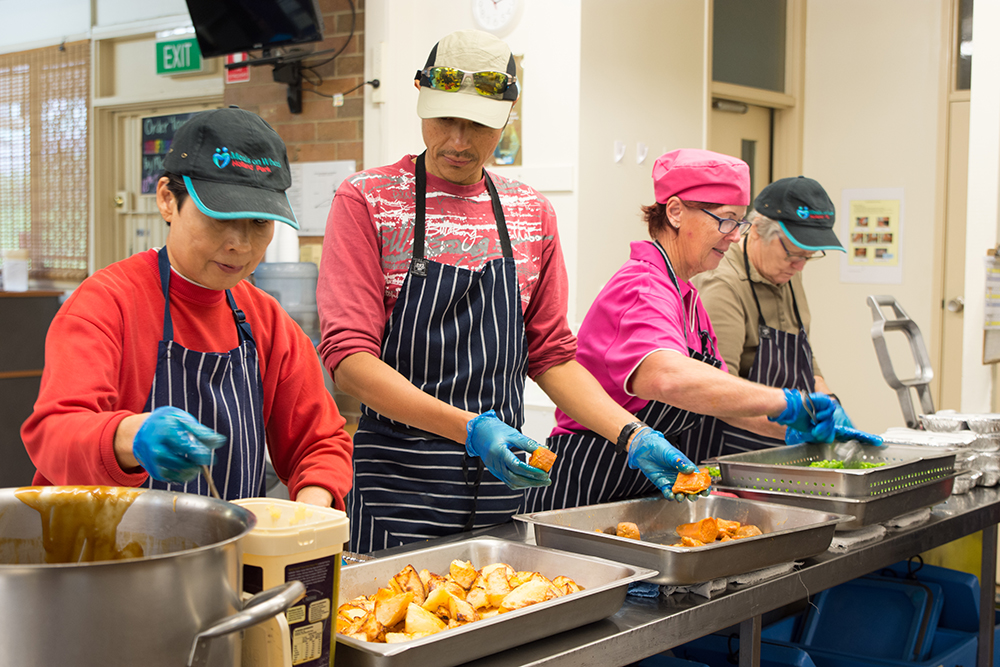 Meals On Wheels volunteers preparing meals.