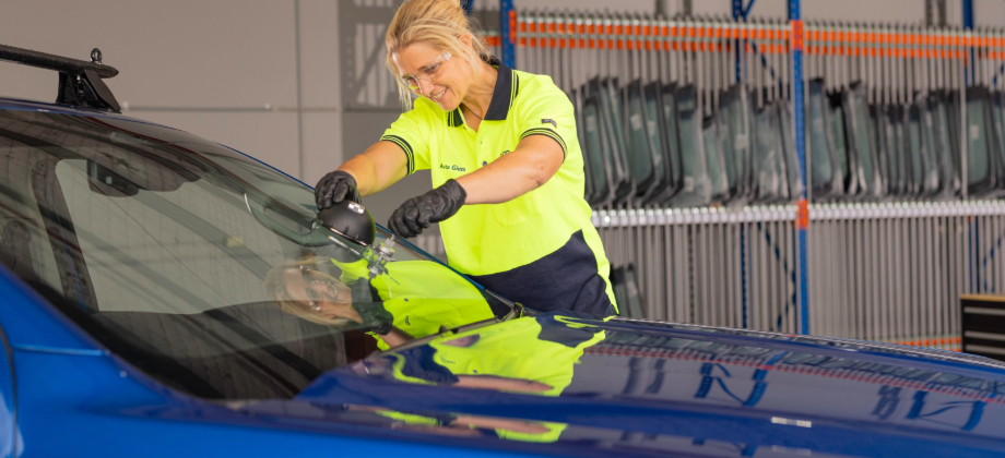 racq woman fixing windscreen on car