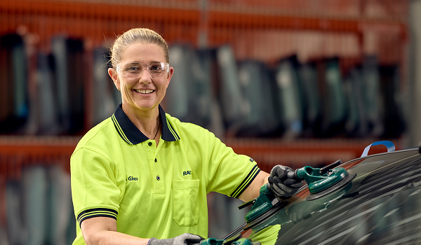 Female RACQ staff changing windscreen on car