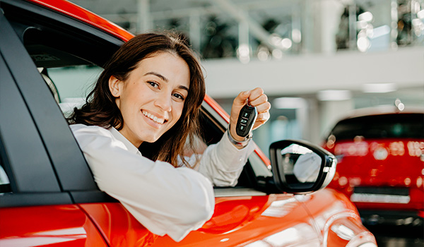 Woman with keys to new car