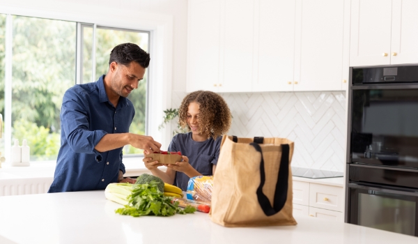 Father and son with groceries on kitchen bench woolworths